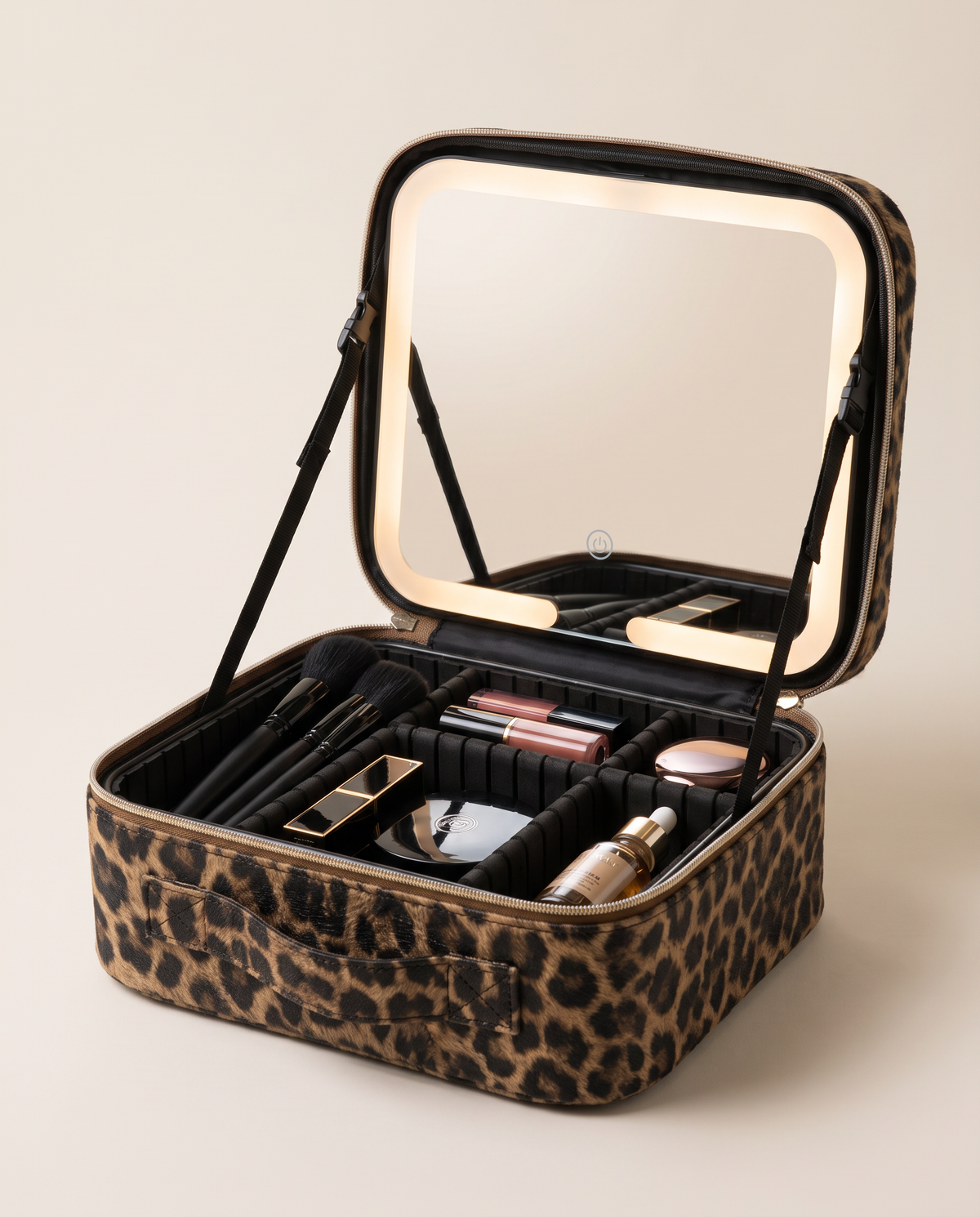 The case open with its LED mirror lit and makeup arranged inside