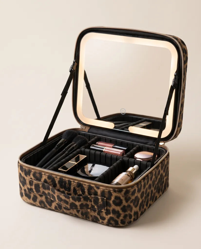 The case open, showing the lit mirror, dividers and brush slots